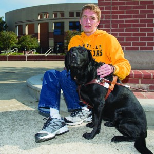 Alex Hubbard, blind Sidelines Editor, and his seeing eye dog, Lark