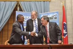 MTSU President Sidney A. McPhee, left, shakes hands with Tennessee Department of Environment and Conservation Commissioner Bob Martineau, right, after signing an agreement Thursday, April 16, at the State Capitol that will expand individual opportunities for earning MTSU course credit and certifications through TDEC’s Fleming Training Center in Murfreesboro, online and at other statewide locations. Tennessee Board of Regents Chancellor John Morgan, center, also signed the agreement. (MTSU photo by Andy Heidt)