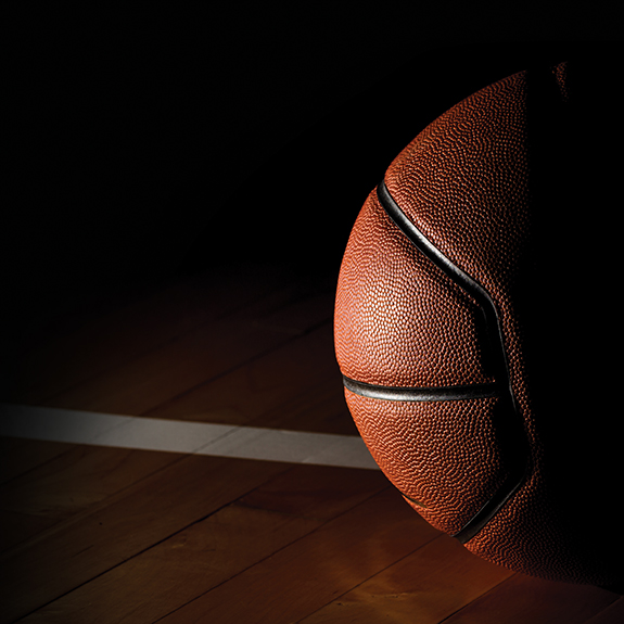 Basketball isolated on court black background with light effect