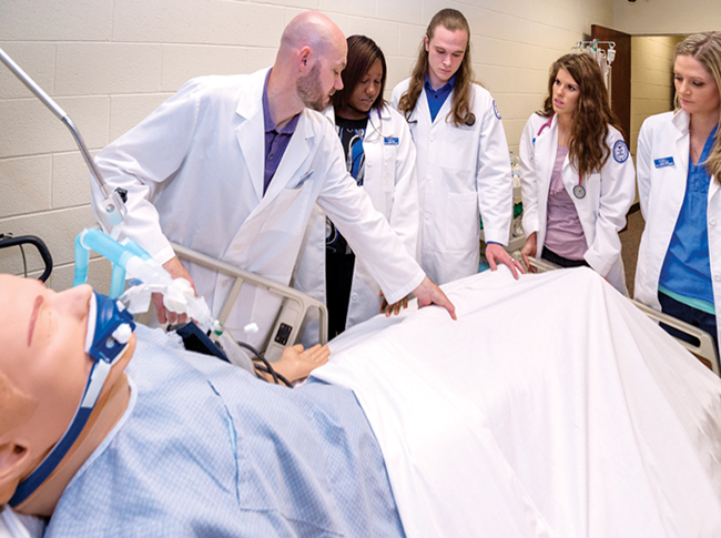 In this spring 2014 photo, from left, MTSU graduate student Todd Vickrey works in a nursing lab with nursing students LaQwell Cheart, Jonathan Holland, Lauren Sliger, and Hanna Lovelady. (MTSU file photo by Andy Heidt)