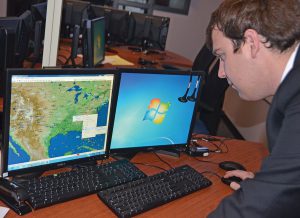 MTSU senior aerospace major Evan Lester calls up The Weather Company's WSI Fusion weather software that students will begin utilizing in the fall. Lester, who graduates in May, will return as a graduate student and continue overseeing the NASA FOCUS Lab. (MTSU photo by Randy Weiler)