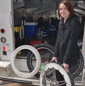 MTSU lunar rover team member Kelly Maynard is shown with two of the team's distinctive white-ribbed tires being used in this year's NASA Human Exploration Rover Challenge April 8-9 in Huntsville, Alabama. (MTSU photo by Randy Weiler)