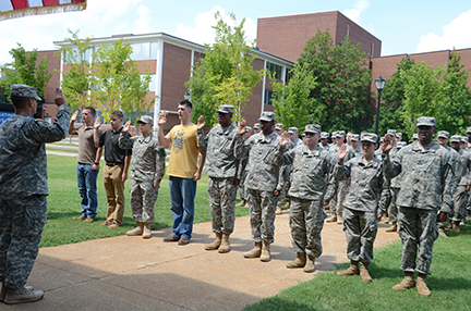 MTSU professor of military science Joel Miller administers the ROTC contracting oath to (from left) Brian Roy of Murfreesboro, Tyler Holweg of Morristown, Tenn., Vagif Seidor of Fairfax, Va., Damien Parker of Centerville, Tenn., Divine McHenry of Fort Dix, N.J., Shade Manning of Eagleville, Tenn., Jason Seiber of Knoxville, Tenn., Kylie Youngston of Savannah, Tenn., and Fredrick Eddins of Nashville. The Aug. 22 ceremoney took place on the lawn in front of Forrest Hall. (Photo by MTSU News and Media Relations)